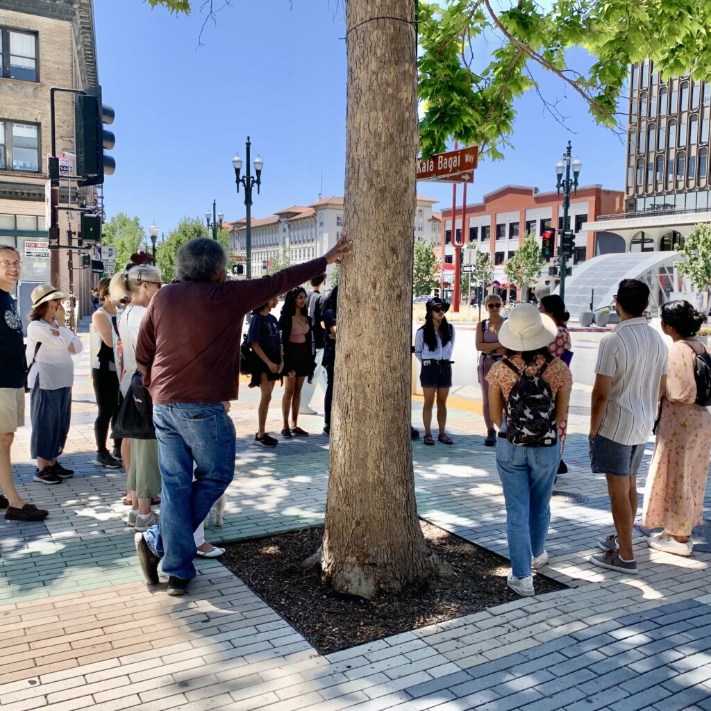 People standing in a circle on Kala Bagai Way